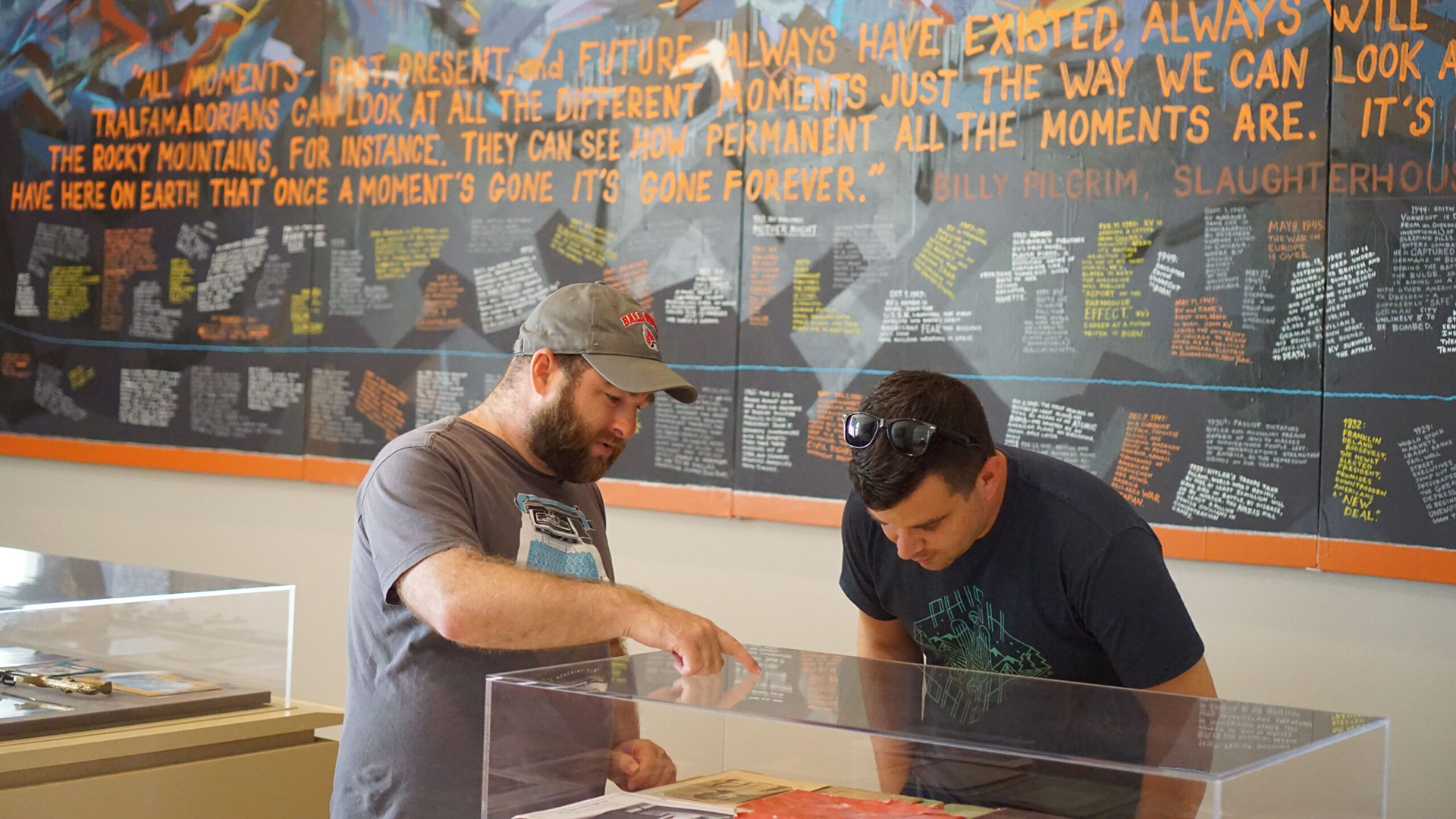 People looking in a glass exhibit case